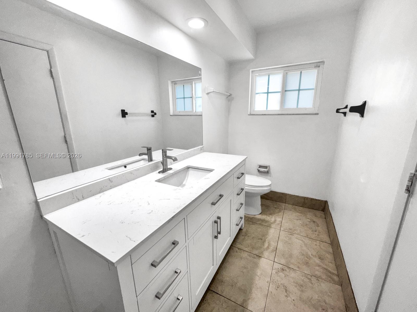 6802 Southwest 34th Court Miramar, FL 33023 - Photo 24 of 41 a bathroom with a sink and a mirror