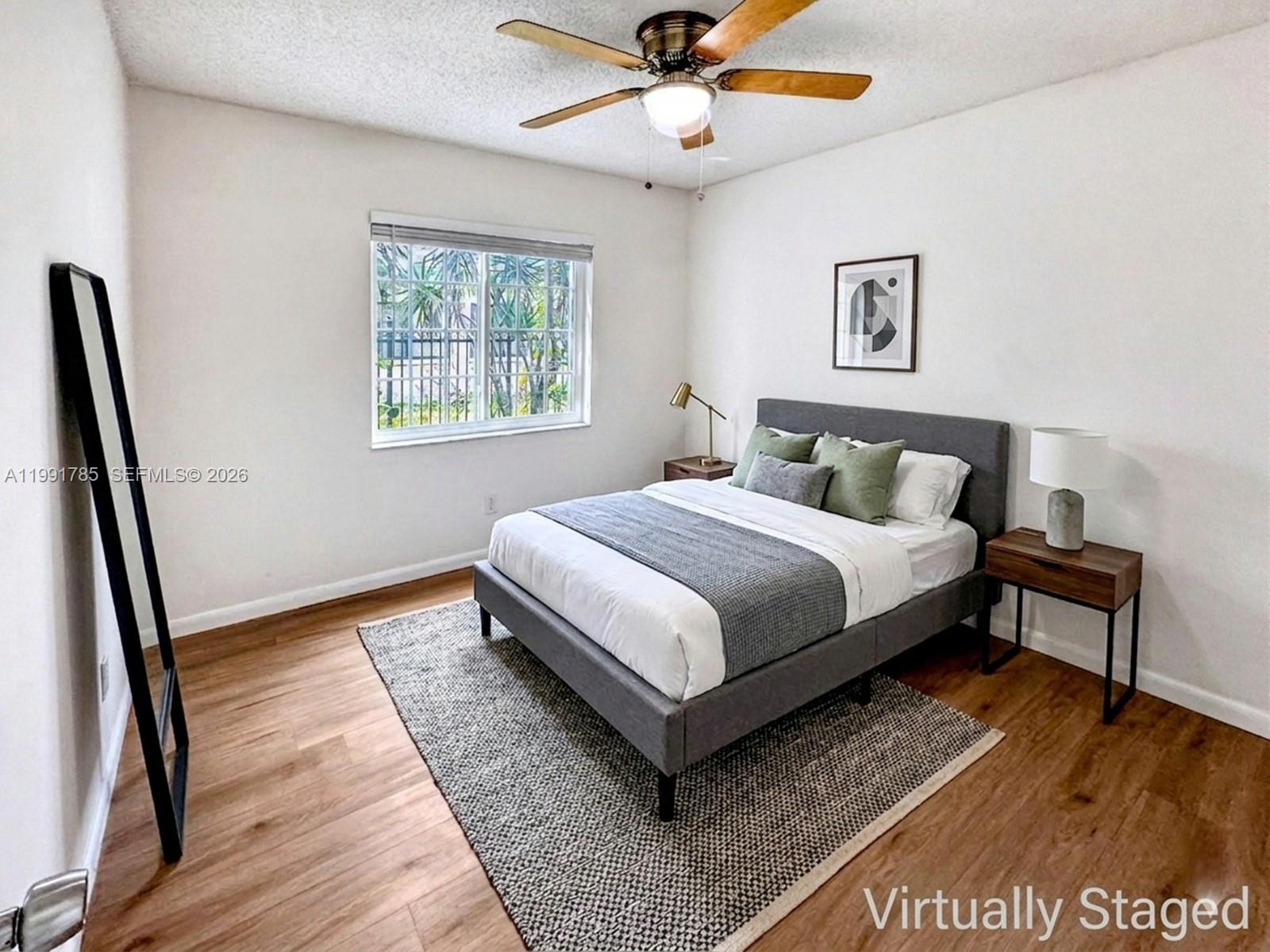 6802 Southwest 34th Court Miramar, FL 33023 - Photo 29 of 41 a bedroom with a bed and a large window