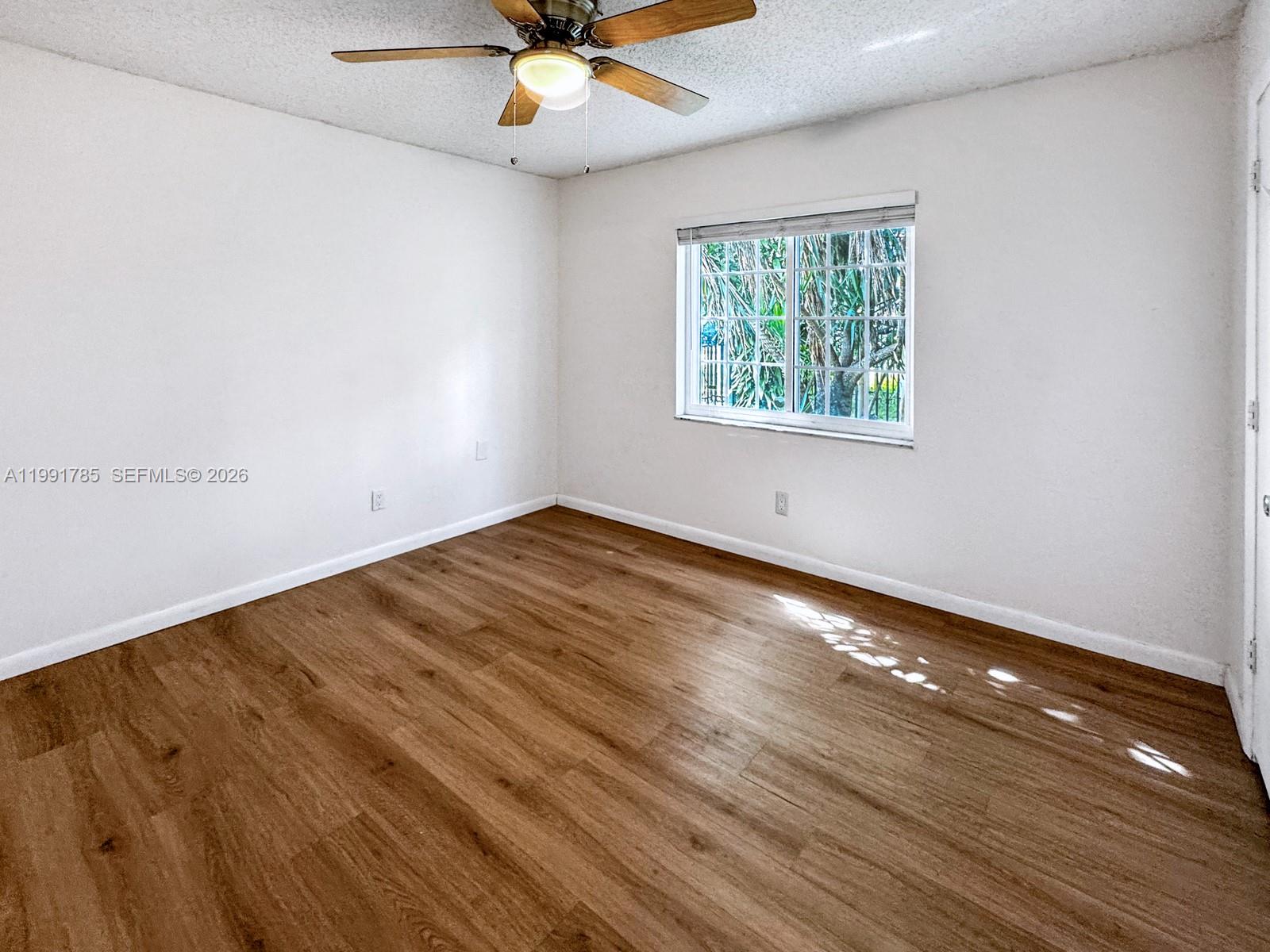 6802 Southwest 34th Court Miramar, FL 33023 - Photo 30 of 41 an empty room with a window and a ceiling fan