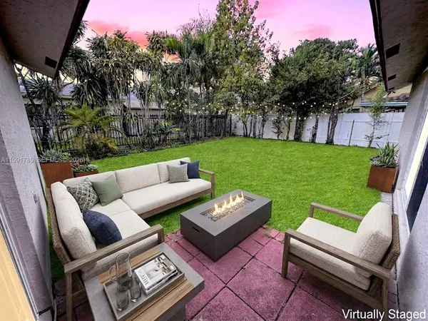 a view of a backyard with large trees