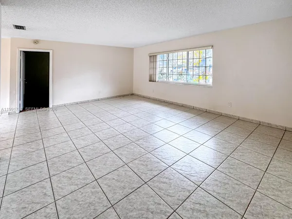 a view of an empty room and window