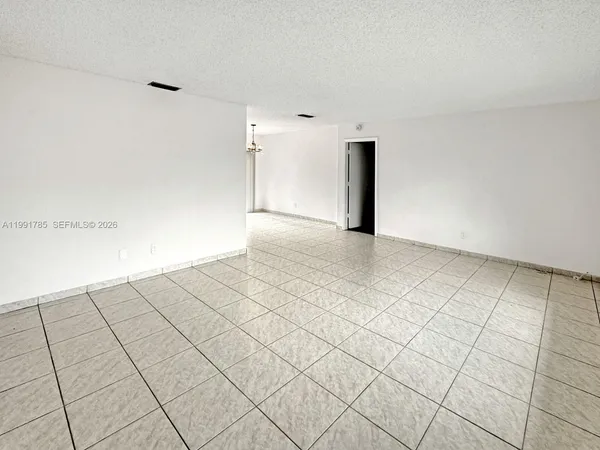 a view of a room with an empty space and a sink