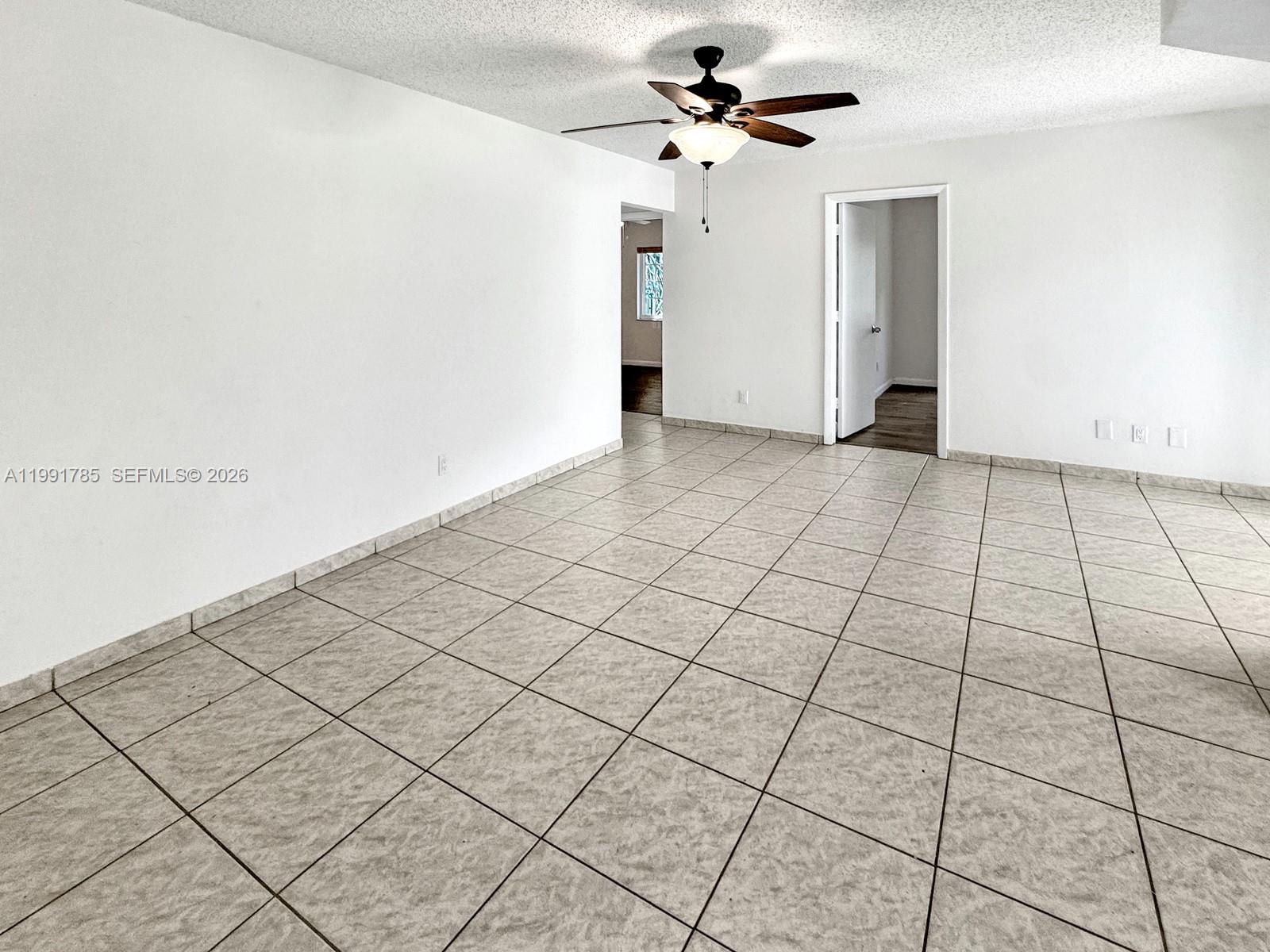 6802 Southwest 34th Court Miramar, FL 33023 - Photo 7 of 41 a view of a livingroom with a chandelier fan and windows