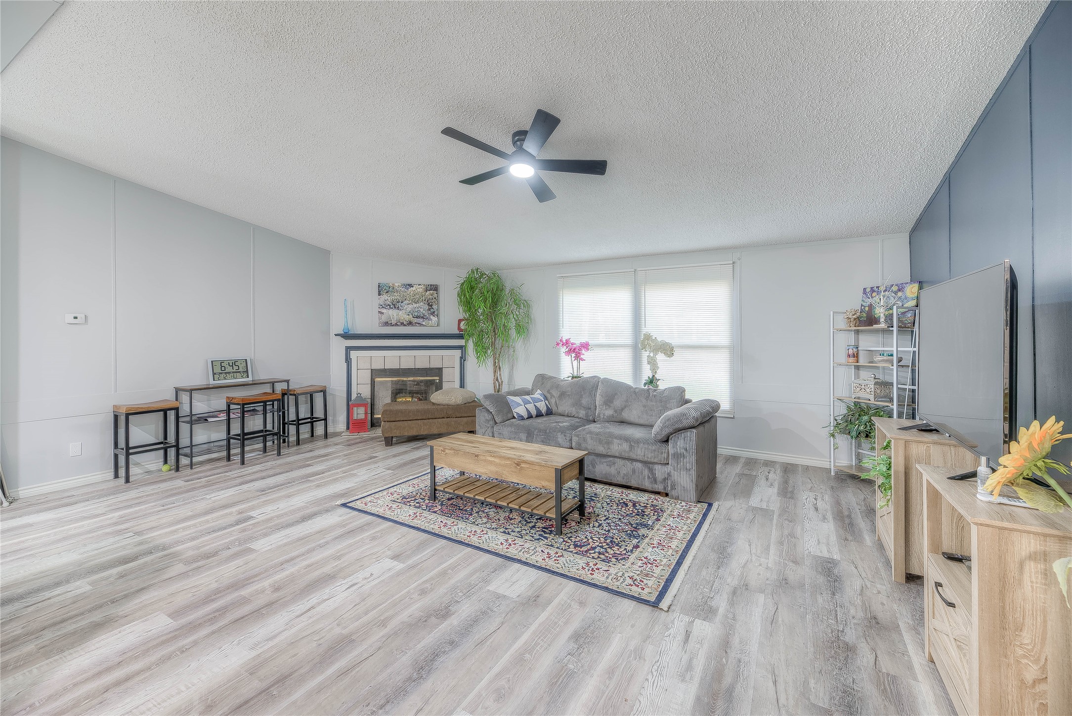 17709 Pine View Drive Conroe, TX 77302 - Photo 9 of 26 a living room with furniture a fireplace and a table