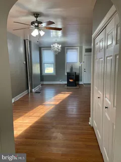 a view of a livingroom with wooden floor and staircase