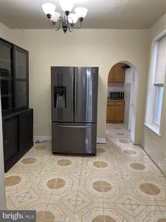 a kitchen with stainless steel appliances granite countertop a refrigerator a stove and a sink