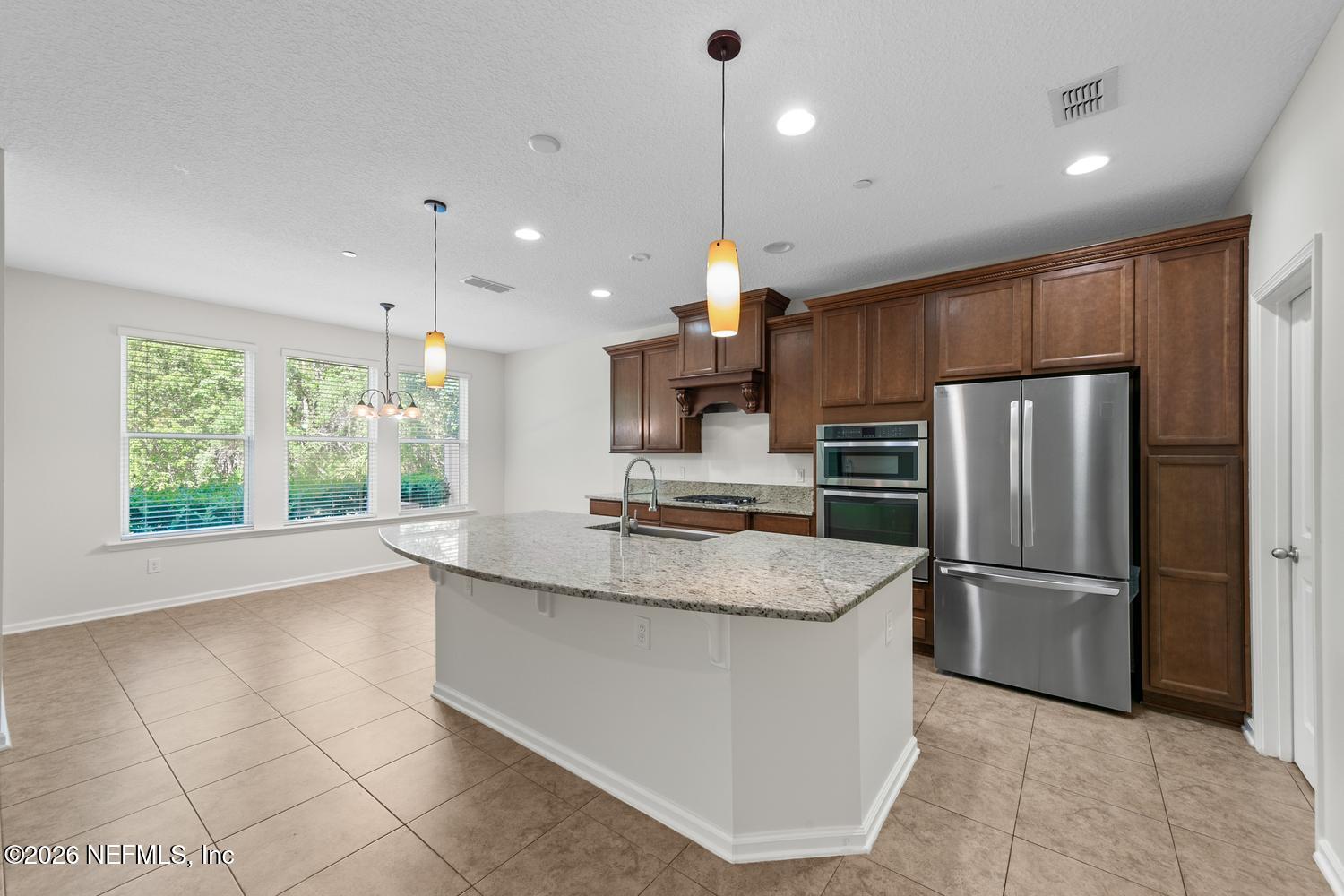 29 Myrtle Park Point Ponte Vedra, FL 32081 - Photo 2 of 59 a large kitchen with granite countertop a large counter top stainless steel appliances cabinets and a large window