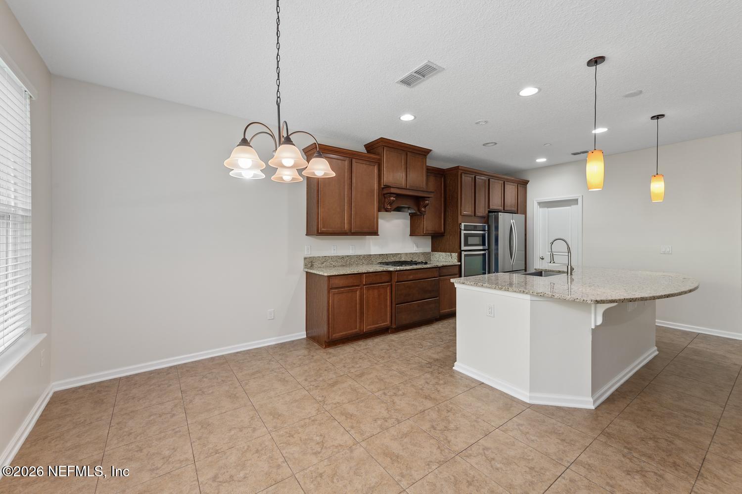 29 Myrtle Park Point Ponte Vedra, FL 32081 - Photo 24 of 59 a kitchen with kitchen island a sink stainless steel appliances and cabinets