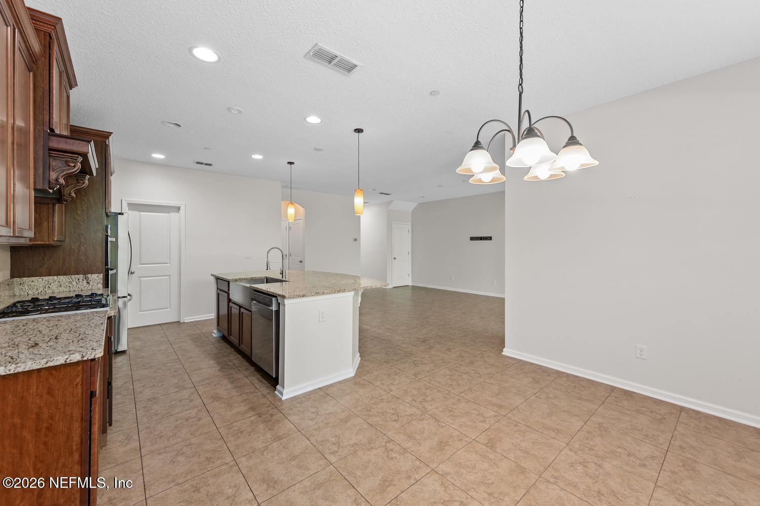 29 Myrtle Park Point Ponte Vedra, FL 32081 - Photo 25 of 59 a large white kitchen with a large island oven a stove and a sink with granite countertops