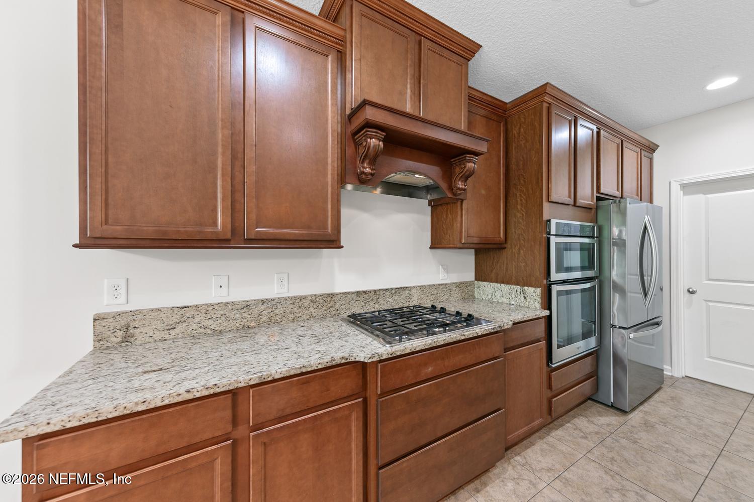 29 Myrtle Park Point Ponte Vedra, FL 32081 - Photo 26 of 59 a kitchen with granite countertop stainless steel appliances and wooden cabinets