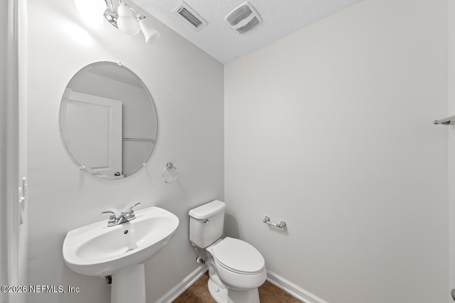 29 Myrtle Park Point Ponte Vedra, FL 32081 - Photo 28 of 59 a bathroom with a toilet a sink and mirror