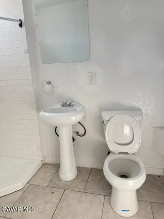 a bathroom with a toilet and a mirror