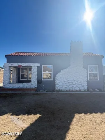 a view of a house with a snow in the background