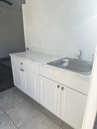 a view with a sink and cabinets
