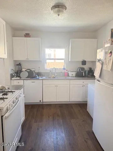 a kitchen with a sink a stove and cabinets