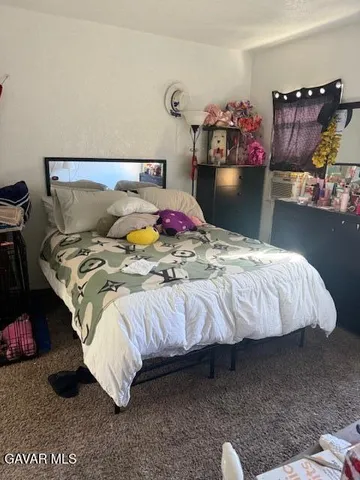 a bedroom with a bed and a table