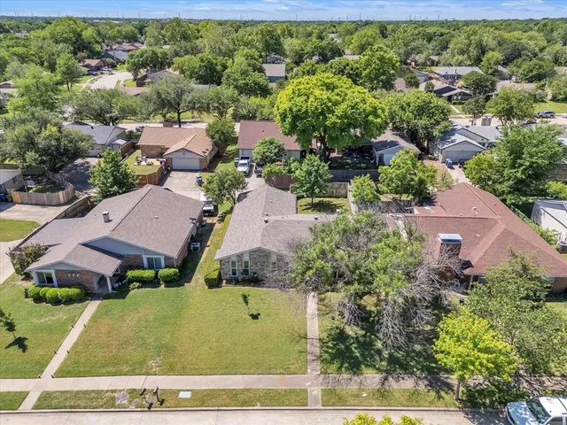 an aerial view of multiple houses with yard