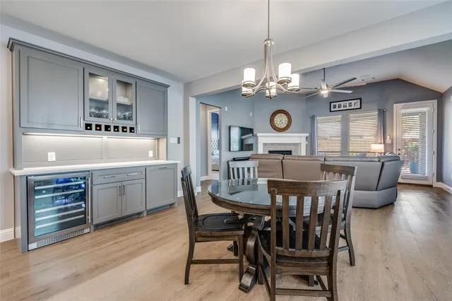 a view of a dining room with furniture a chandelier and wooden floor