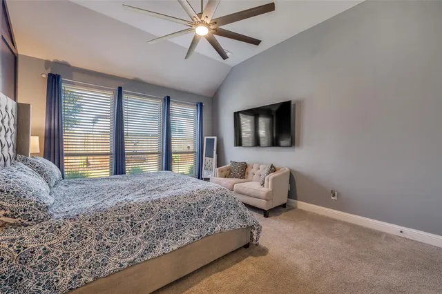 a living room with a bed furniture and a flat screen tv