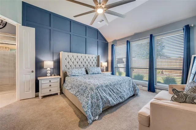 a spacious bedroom with a bed and a couch