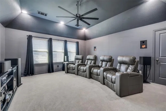 a large bedroom with furniture and a large window