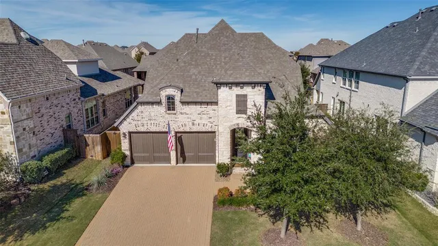 a aerial view of a house with a yard and potted plants