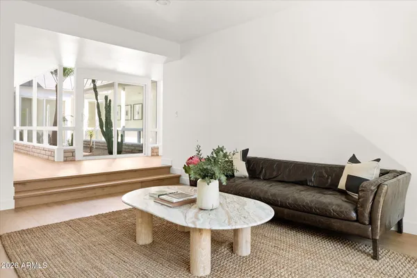 a bedroom with a large bed and a flat tv screen on dresser