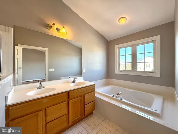 a spacious bathroom with a bathtub sink and toilet