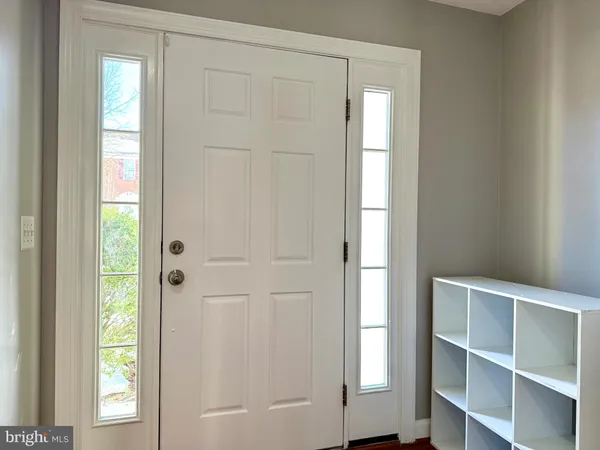 a view of an empty room with closet and a window