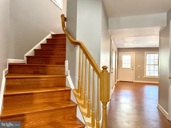 a view of entryway and hall with wooden floor