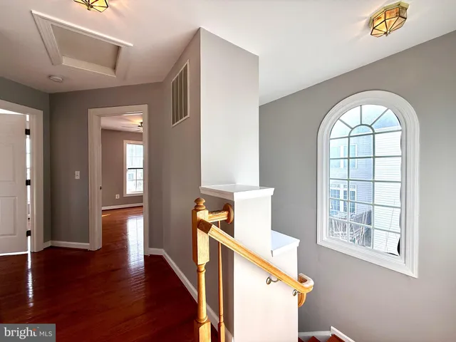 a kitchen with stainless steel appliances granite countertop a refrigerator a sink a stove and a wooden floors