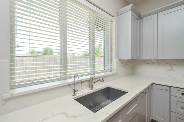 a kitchen with granite countertop a sink and a window