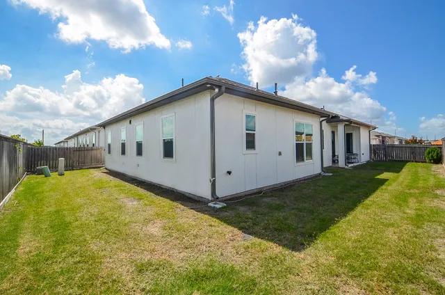 a view of a white house with a yard