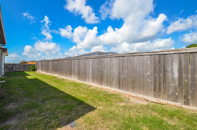 a view of backyard with trampoline