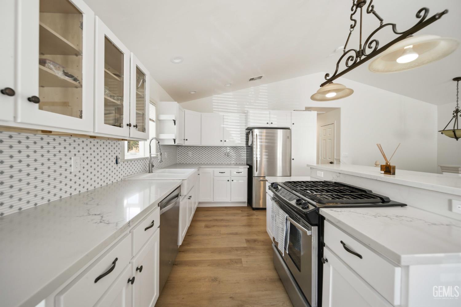 Undisclosed Address Lebec, CA 93243 - Photo 14 of 29 a kitchen with stainless steel appliances a refrigerator a sink and white cabinets