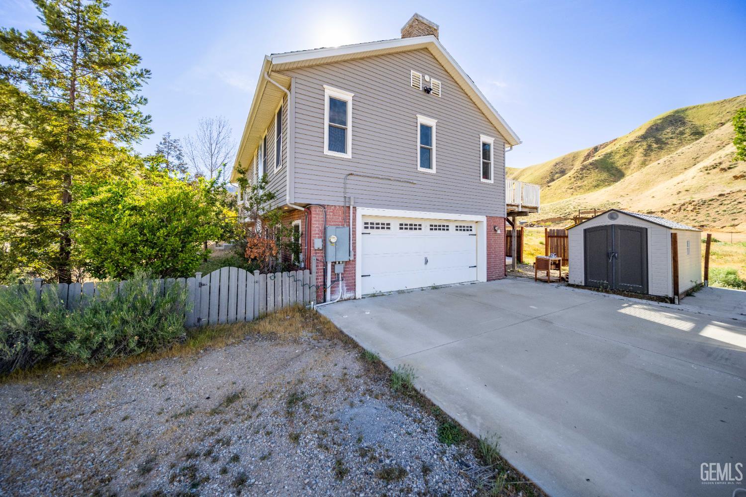 Undisclosed Address Lebec, CA 93243 - Photo 2 of 29 a front view of a house with a yard and garage