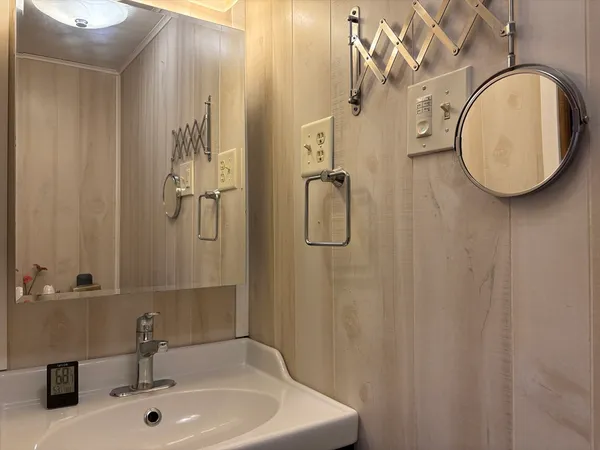 a bathroom with a sink and mirror