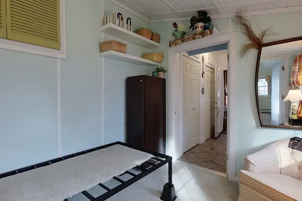 a view of a hallway with a dining room and wooden floor