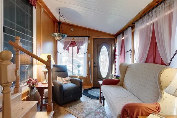 a living room filled with furniture and a window