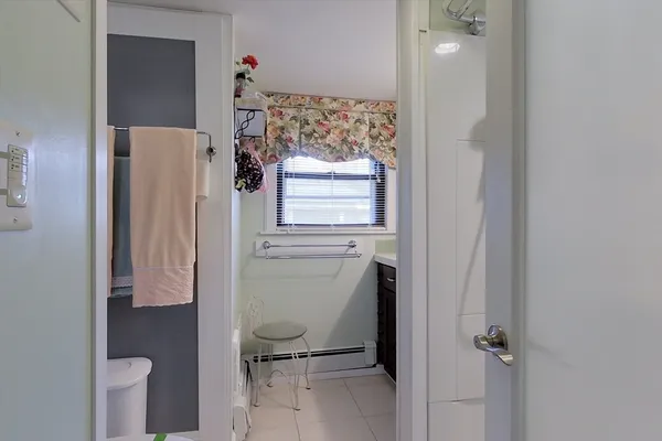 a bathroom with a toilet and a shower