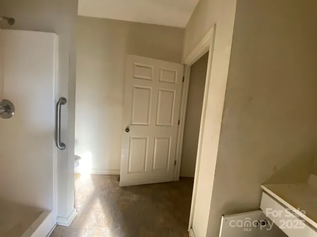a view of a room with wooden floor and bathroom