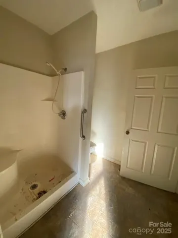 a bathroom with a tub and shower