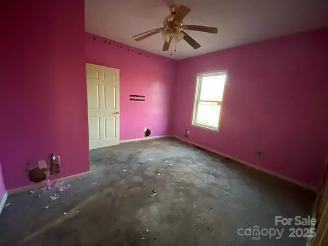 a view of a livingroom with a ceiling fan and window
