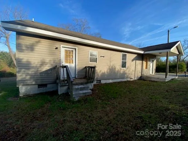 a backyard of a house with barbeque oven table and chairs