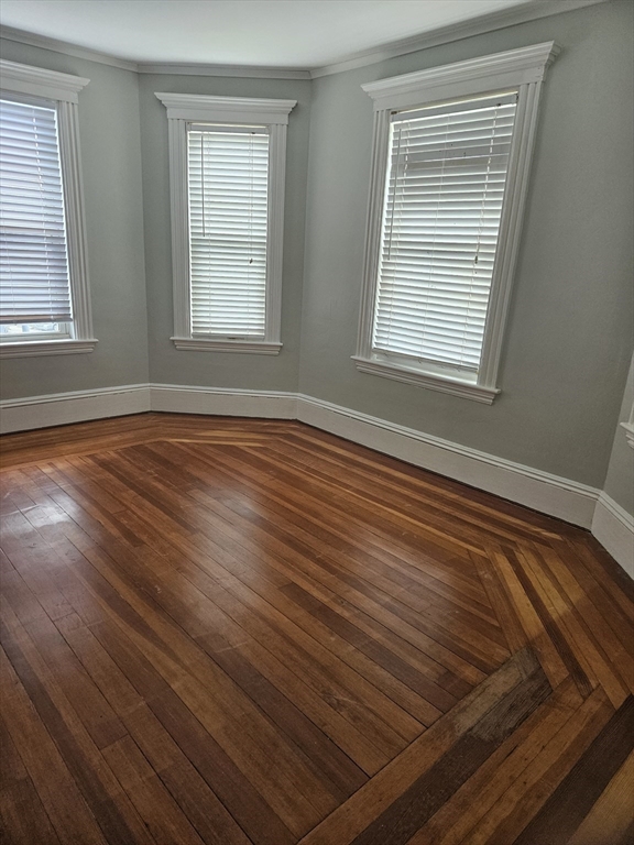 21 Baldwin Street, Unit 1 Malden, MA 02148 - Photo 11 of 19 a view of an empty room with wooden floor and a window