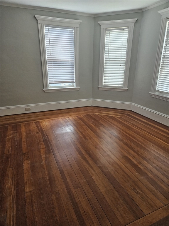 21 Baldwin Street, Unit 1 Malden, MA 02148 - Photo 12 of 19 an empty room with wooden floor and windows