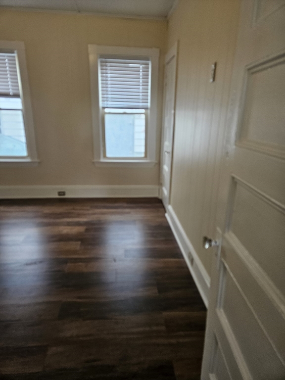 21 Baldwin Street, Unit 1 Malden, MA 02148 - Photo 14 of 19 a view of an empty room with wooden floor and a window