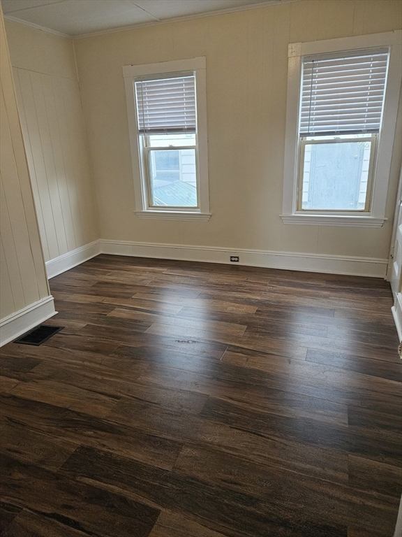 21 Baldwin Street, Unit 1 Malden, MA 02148 - Photo 15 of 19 an empty room with wooden floor and windows