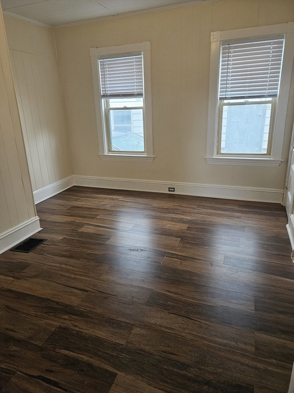 21 Baldwin Street, Unit 1 Malden, MA 02148 - Photo 17 of 19 an empty room with wooden floor and windows