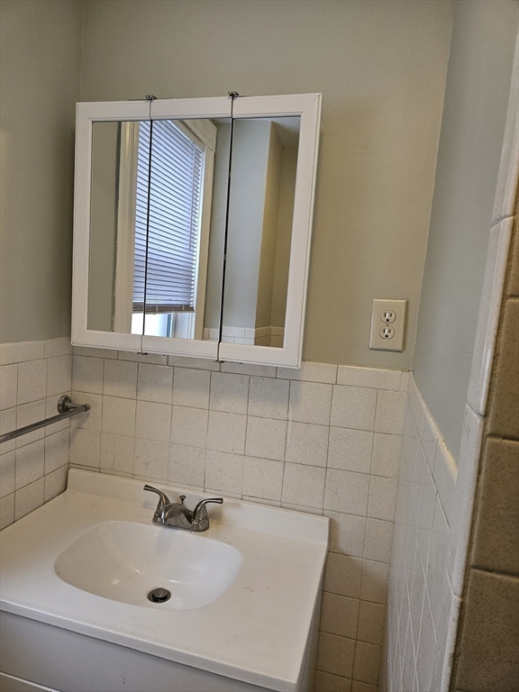 21 Baldwin Street, Unit 1 Malden, MA 02148 - Photo 18 of 19 a bathroom with a sink and a mirror